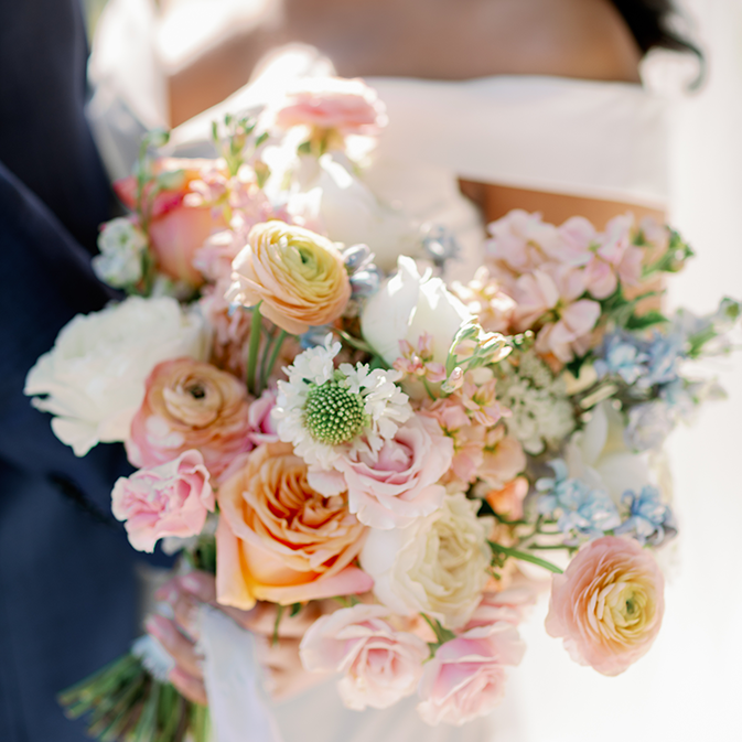bouquet of wedding flowers in pink, peach, blue, white and yellow