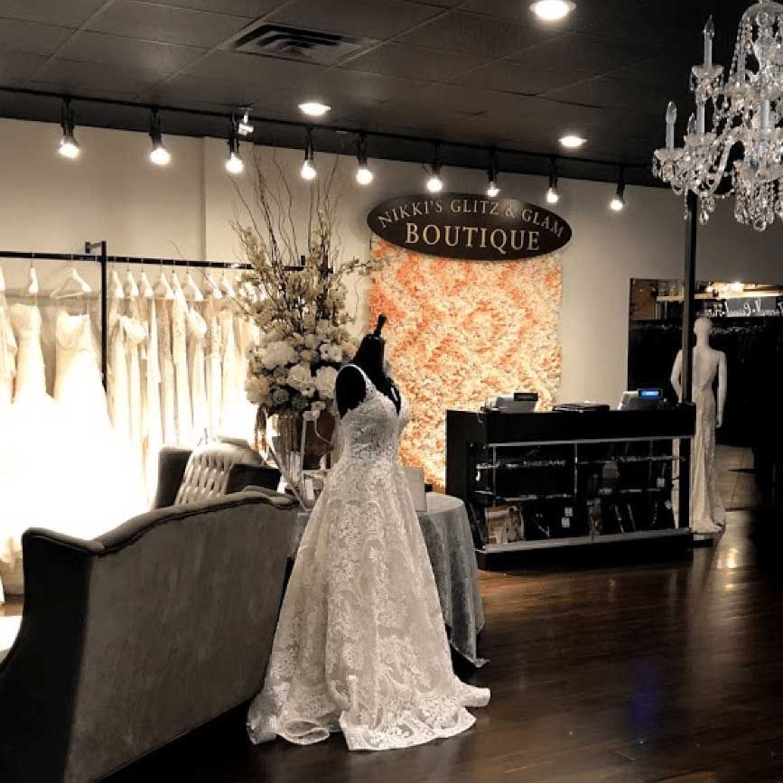 Image of the interior of Nikki's Glitz and Glam Boutique featuring comfortable seating and wedding dress displays